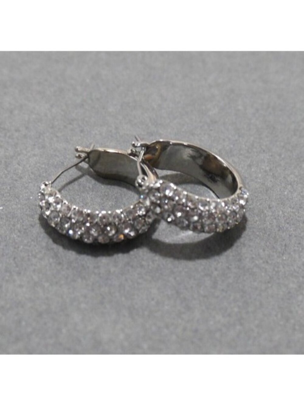 Silver tone hoop earrings with clear stones approx 3/4" long